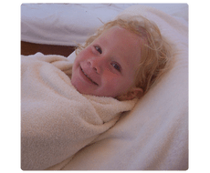 child in cozy towel after his swim lesson review