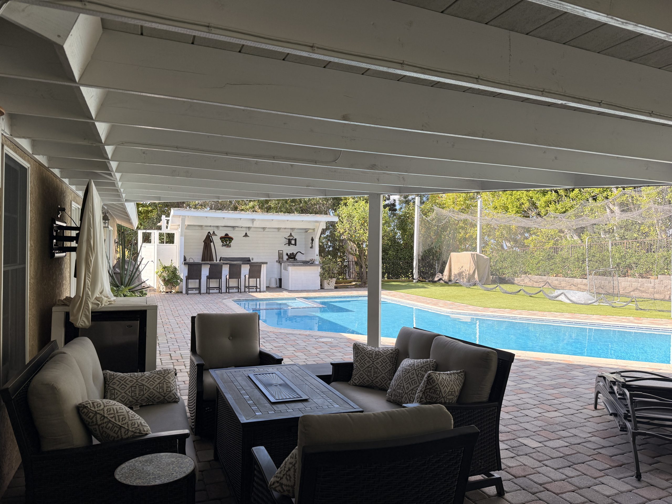 Covered seating beside the swimming pool.
